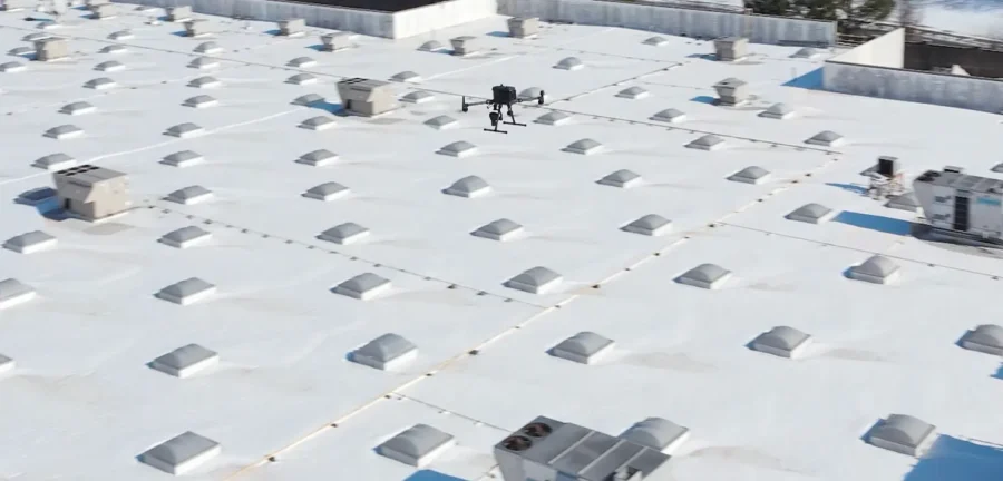 drone assessing roof damage of an industrial building
