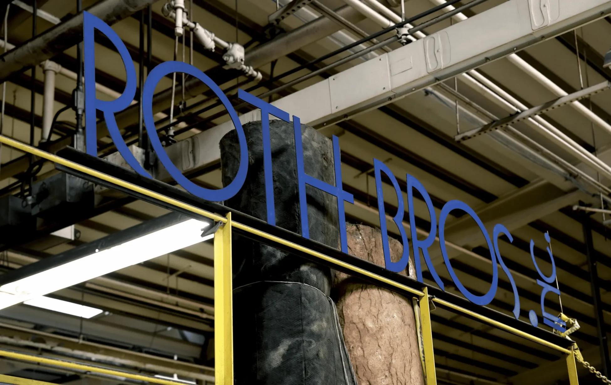 large sign inside a warehouse that reads Roth Bros