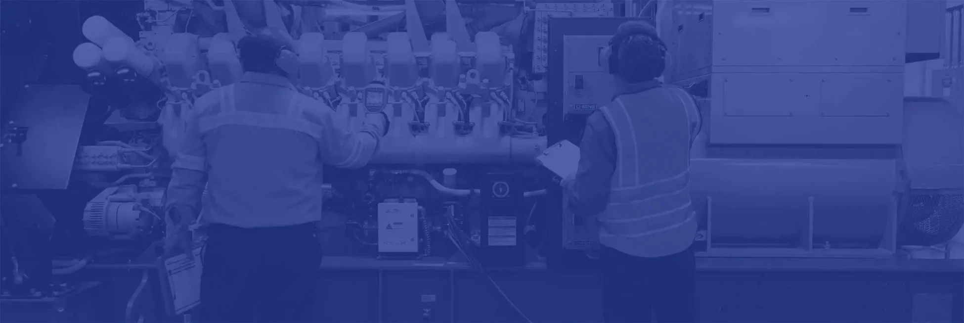 two Roth engineers checking the settings on industrial HVAC equipment